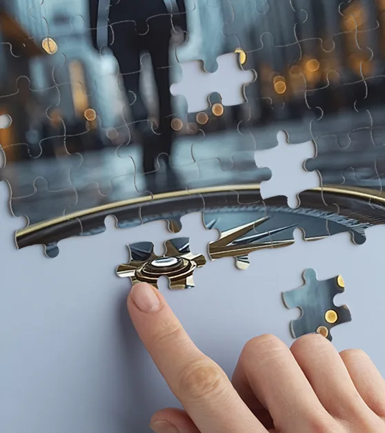A hand placing the final piece of a jigsaw puzzle that shows a compass and a person walking through a city